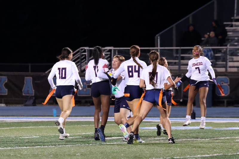Oswego players run to celebrate a pick by Jazmin Hurston, second from left, late in the fourth quarter during the Panthers' 13-7 victory over Joliet West on Tuesday, Oct. 7, 2025.