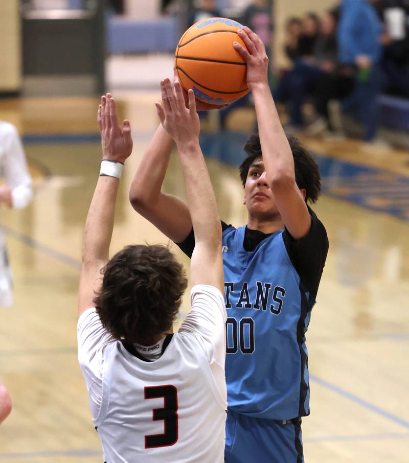 IMSA’s Neil Sitapara shoots over Indian Creek's Logan Schrader Friday, Feb. 6, 2026, during their Little 10 Conference championship game at Somonauk High School.