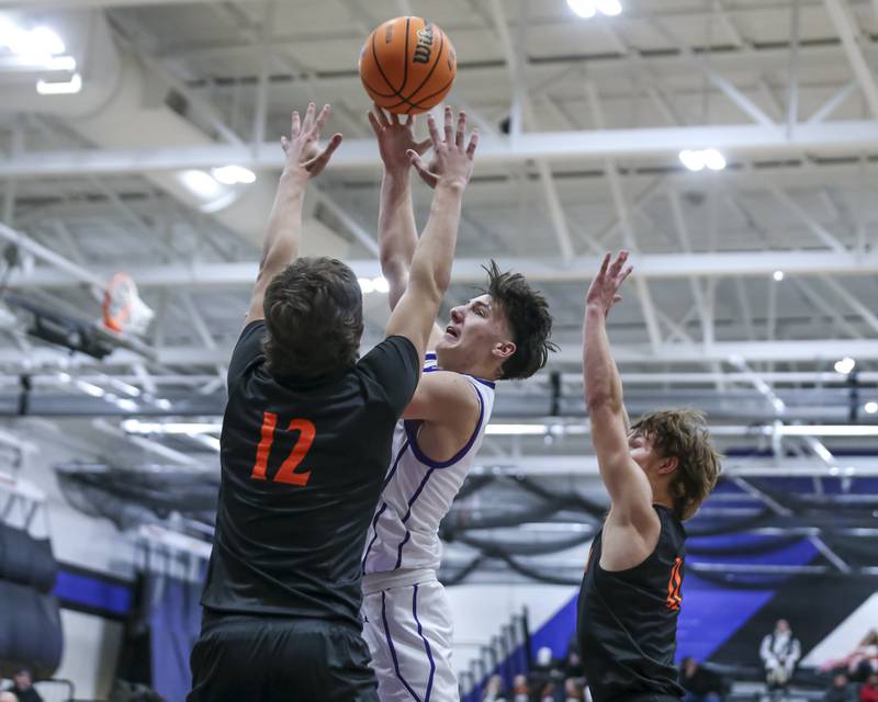 Plano's Ethan Taxis (3) puts up a shot over Sandwich's Charles Behringer (12) during their basketball game between Sandwich at Plano Tuesday, Dec 9, 2025 in Plano.