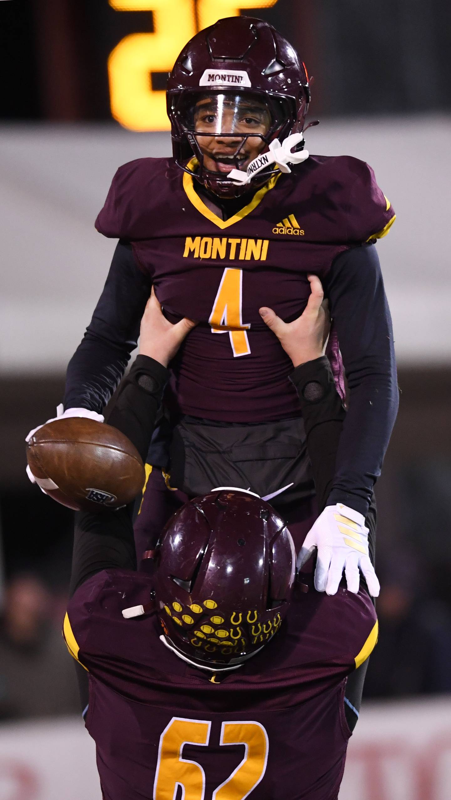Montini's Damacio Ortegon gets lifted in the air by teammate Michael Lombardo after scoring a touchdown during the IHSA Class 4A state championship game against Rochester on Friday, Nov. 28, 2025 in Normal.
