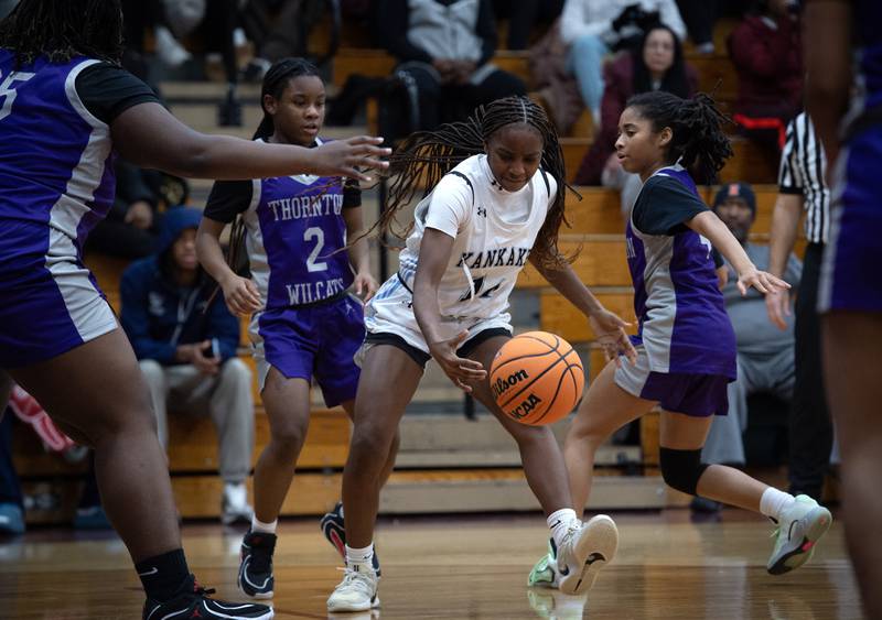 Kankakee's Jasyia Wesby, center, momentarily loses control of the ball in a game against Thornton on Thursday, December 4, 2025.