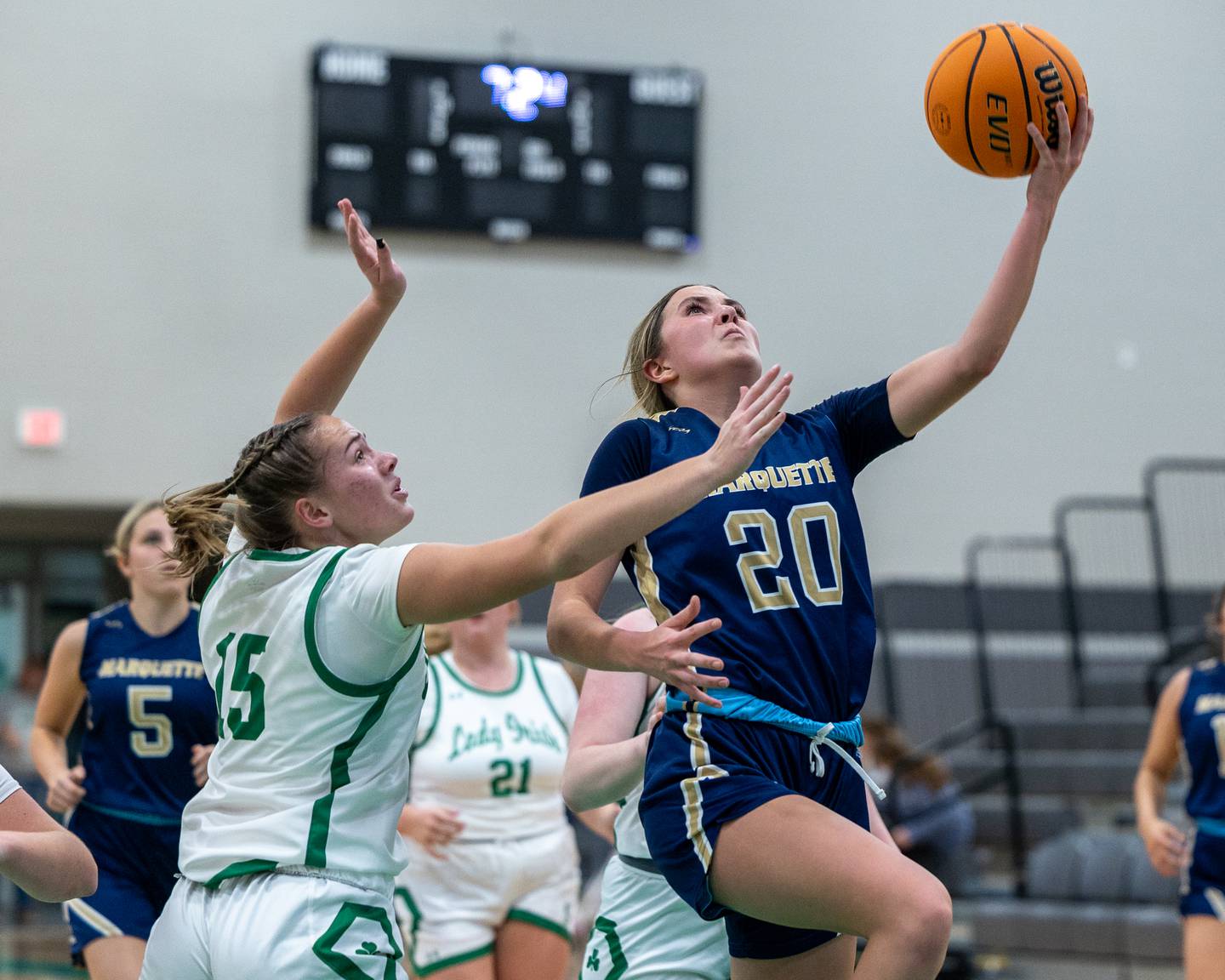 Kaitlyn Davis (20) of Marquette leaps for layup as Kylee Rowley (15) of Seneca attempts to defend in a game earlier this season at Seneca High School in Seneca.