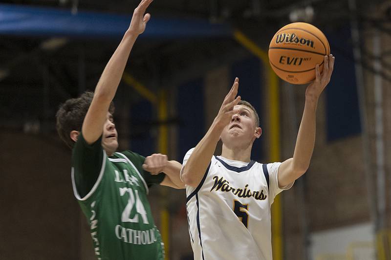 Sterling’s Bryce Hartman scores two against Alleman’s Robbie Wolfe Friday, Dec. 20, 2024, at Sterling High School.