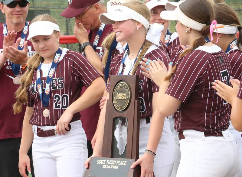 Prairie Ridge's Adysen Kiddy holds the Class 3A State third place trophy after defeating Burbank St. Laurence on Saturday, June 14, 2025 at the Lousville Slugger Complex in Peoria.