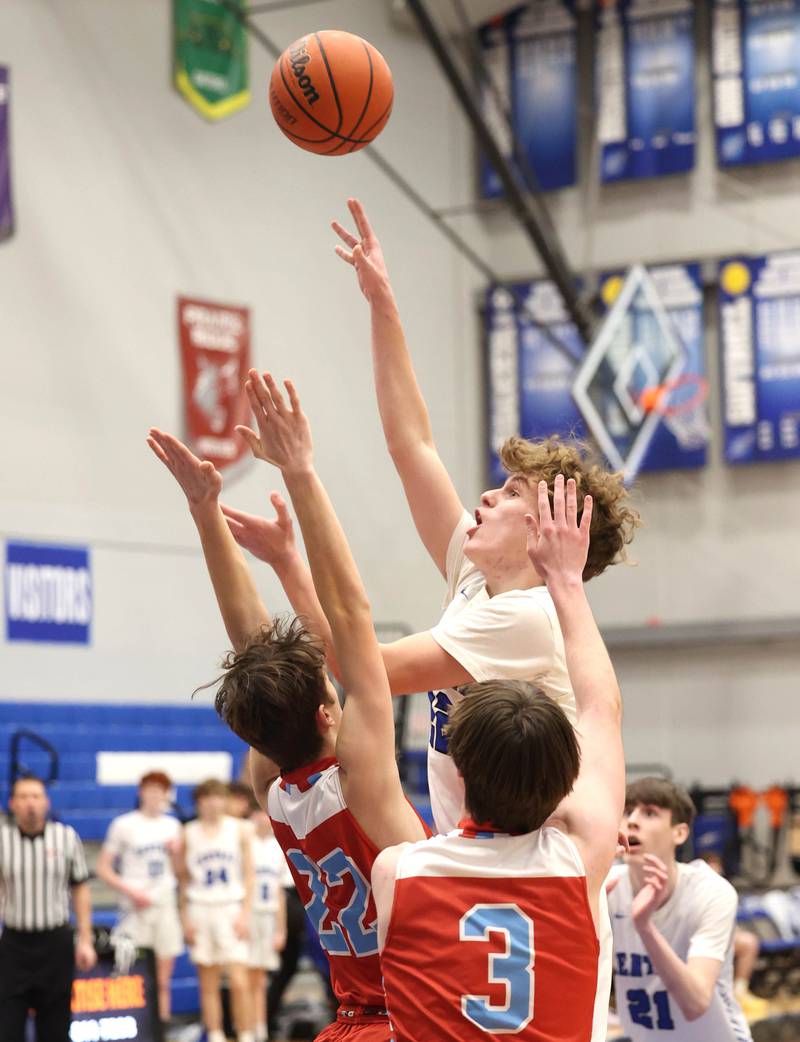 Burlington Central's Logan Goff shoots over two Marian Central defenders Monday, Jan. 15, 2023, during their game in the Burlington Central Martin Luther King Jr. boys basketball tournament.