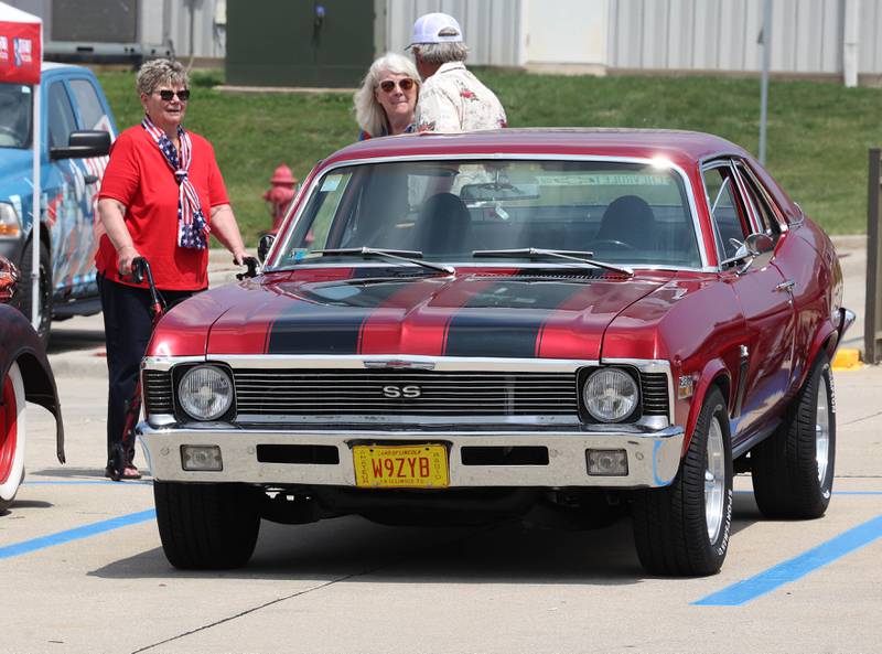 Visitors check out one of the cars Saturday, June 14, 2025, at the Flag Day Car Show in the Hy-Vee parking lot in Sycamore.
