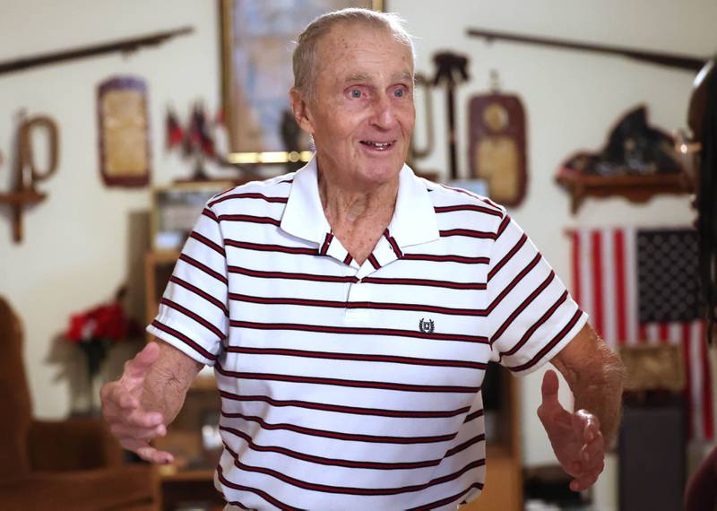 U.S. Army Veteran Jerry Busby smiles as he talks Wednesday, Aug. 28, 2024, about some of the military and law enforcement memorabilia he has collected over the years that adorn the walls of his DeKalb home.