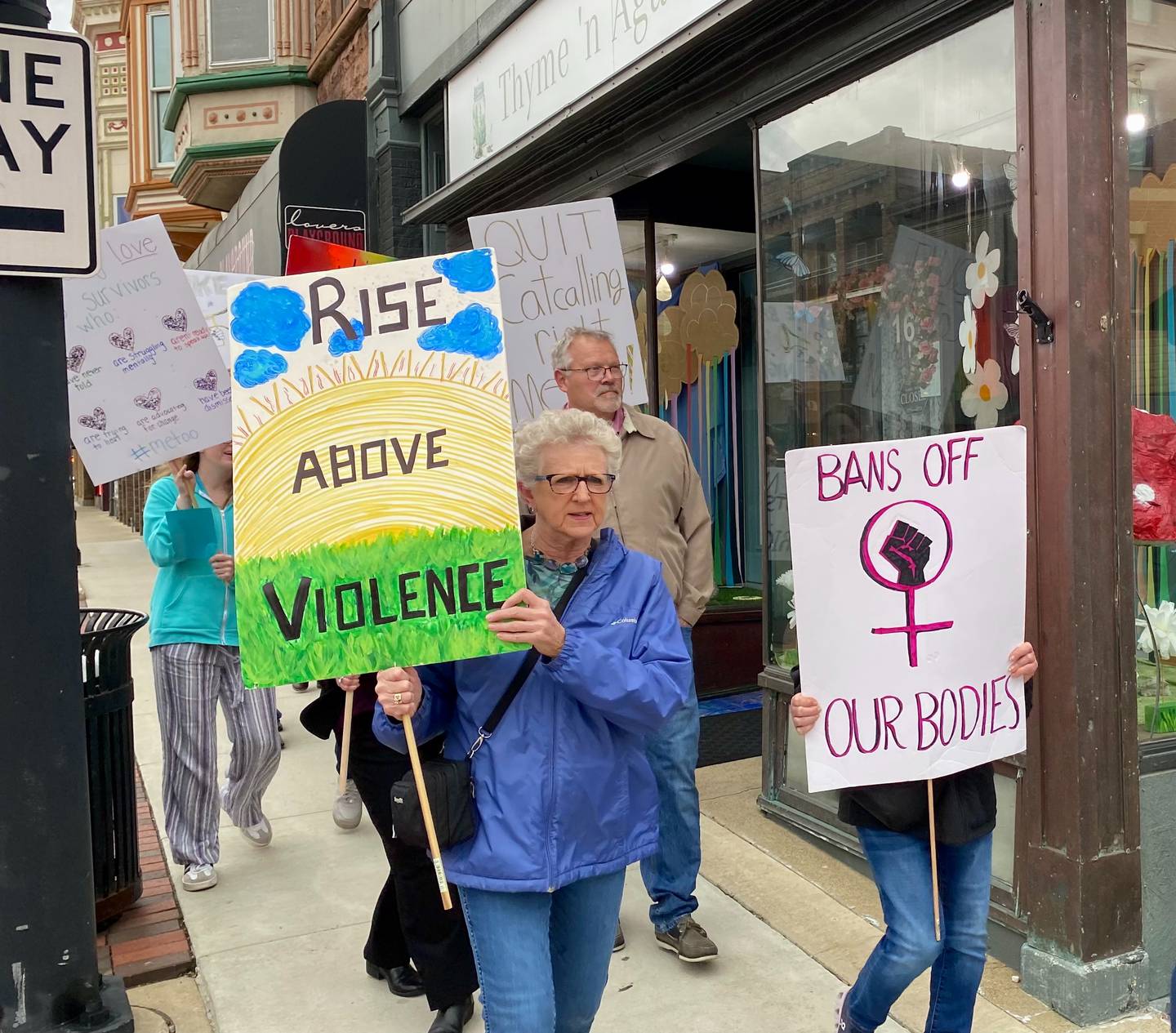 Event-goers at Safe Passage's annual Take Back the Night march down Lincoln Highway toward the Egyptian Theatre in downtown DeKalb on Monday, April 27, 2026. They carried signs to advocate against sexual violence and to mark Sexual Violence Awareness Month, in its 25th year.