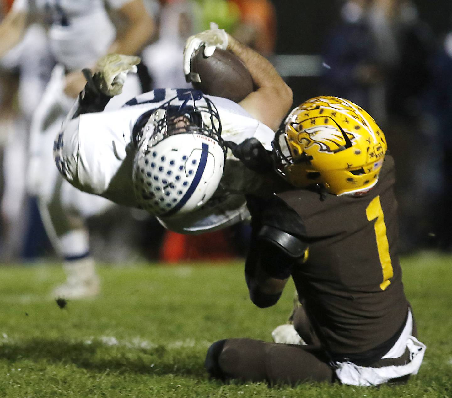 Cary-Grove's Logan Abrams is tackled by Jacobs' Justin Gonzalez during a Fox Valley Conference football game on Friday, Oct. 24, 2025, at Jacobs High School in Algonquin.