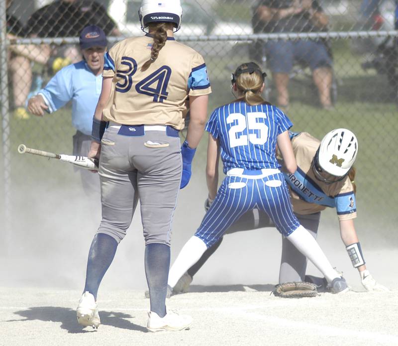 Marquette runners scoce on a passed ball. Newman's Claire Von Holten backs up the play.Marquette traveled to Newman' to play a game on Friday, May 16, 2025