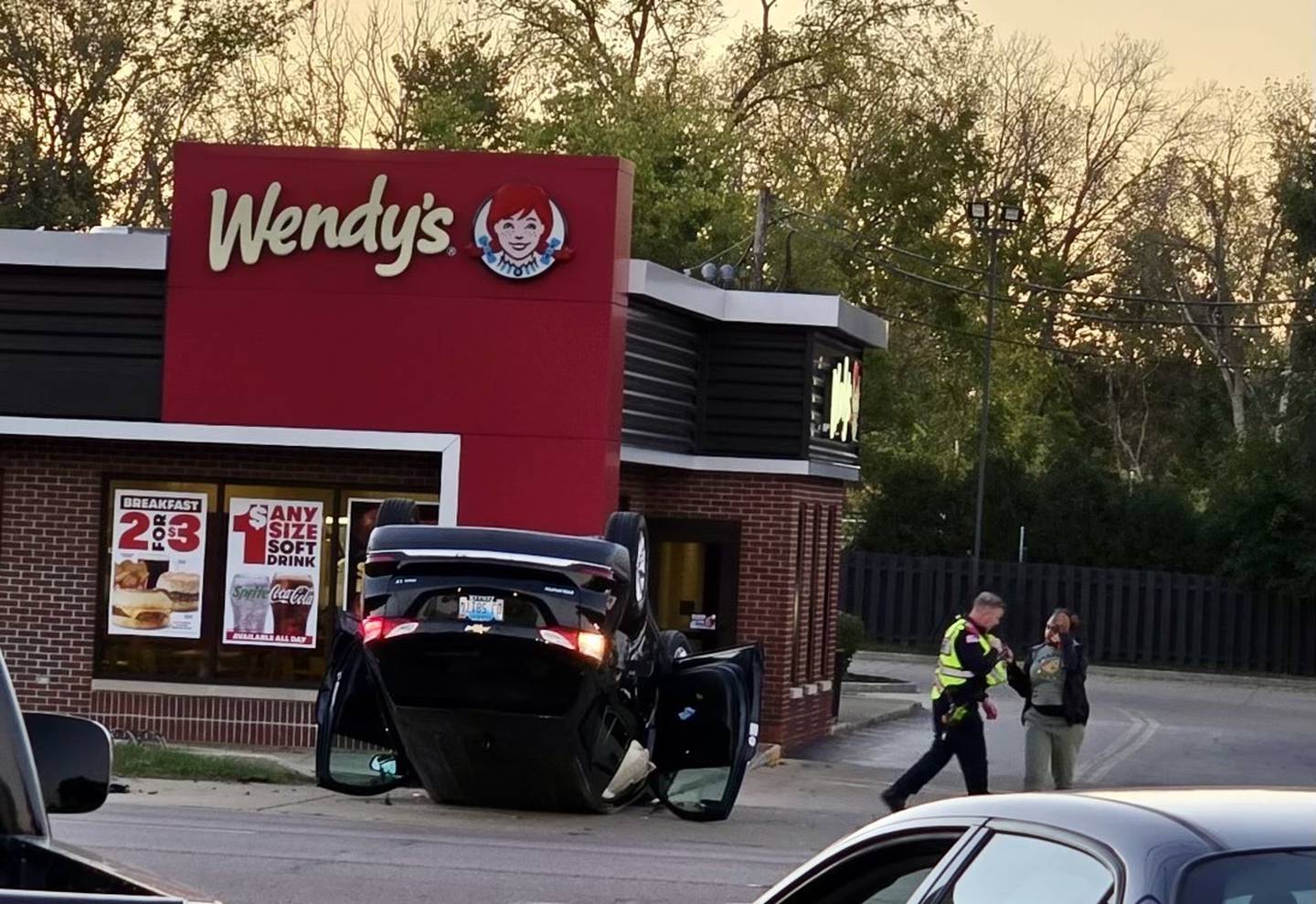 DeKalb police shown at about 6:30 p.m. Monday, Oct. 7, 2024, responding to a flipped black SUV in the parking lot of Wendy's fast food restaurant, 1321 Sycamore Road, DeKalb. One person suffered injuries in the crash.