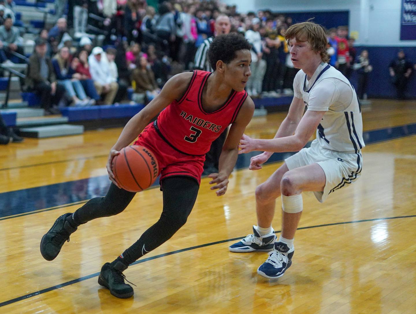 Bolingbrook's Davion Thompson (3) drives the baseline against Oswego East's Andrew Pohlman (21) during a basketball game at Oswego East High School in Oswego on Wednesday, Jan 10, 2024.