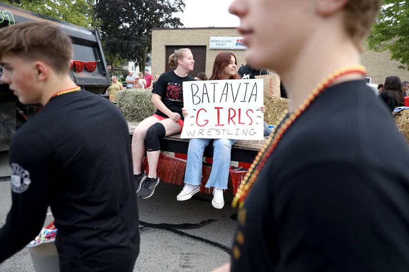 Batavia High School girls wrestlers participate in the school’s annual homecoming parade on Wilson Street on Wednesday, Sept. 20, 2023.