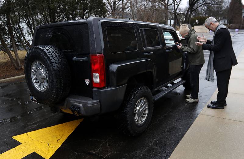 Steve Neil of Stephen Ministry  and Rev. Jeffry Bross, the senior pastor at the United Methodist Church of Libertyville, pray with visitors during a Drive-Thru Ash Wednesday Blessing on Wednesday, March 05, 2025, at the United Methodist Church of Libertyville. This was the first time the church has offered a Drive-Thru Ash Wednesday Blessing, that created a simple convenient way for individuals to receive ashes and mark the beginning of the Lenten season.