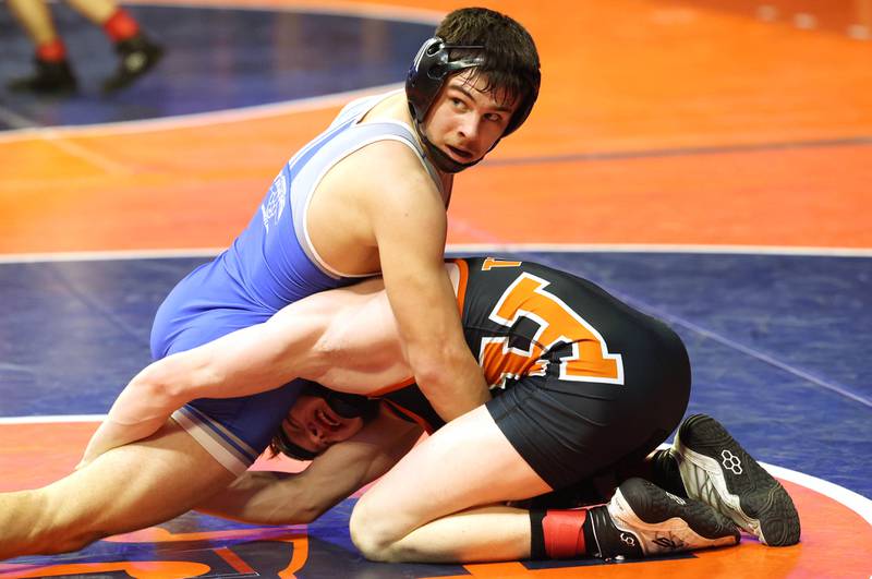 Princeton’s Augie Christiansen wrestles Herrin’s Blue Bishop in the Class 1A 145 pound 3rd place match Saturday, Feb. 18, 2023, in the IHSA individual state wrestling finals in the State Farm Center at the University of Illinois in Champaign.