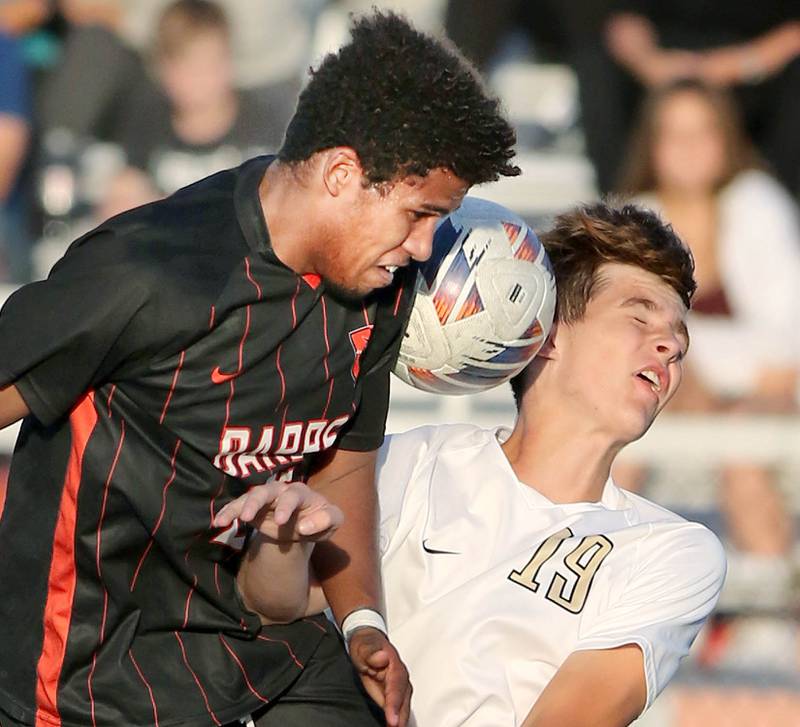 DeKalb's Josiah Antimo (left) and Sycamore's Charlie Roots go up for a header during their game Tuesday, Oct. 4, 2022, at DeKalb High School.