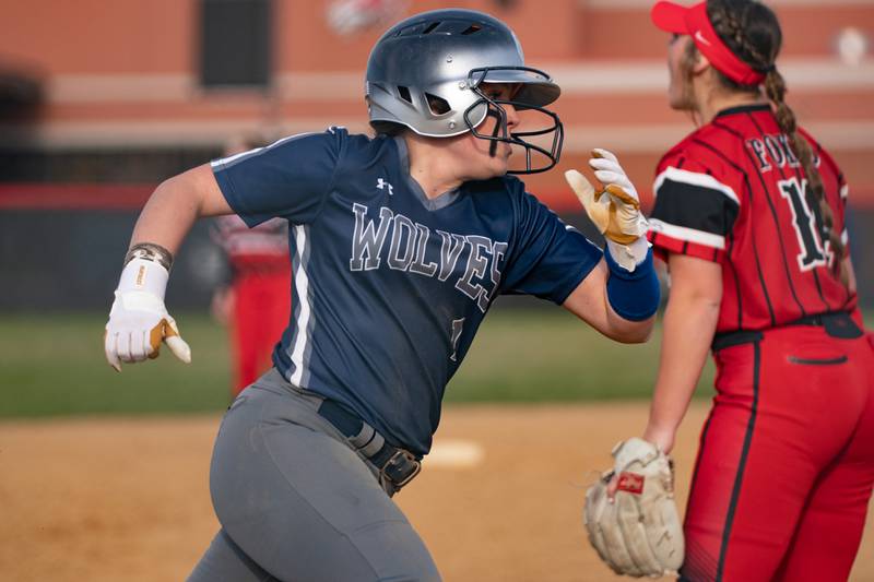Oswego East's Gracie Vlach (1) rounds third base to score a run against Yorkville during a softball game at Yorkville High School on Tuesday, April 19, 2022.