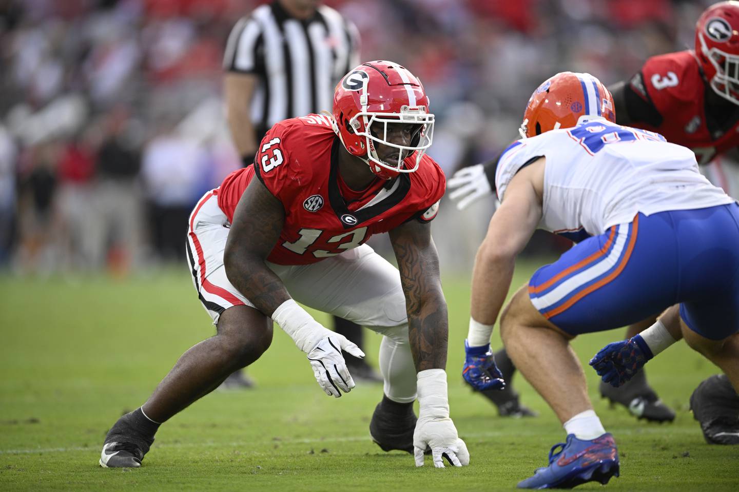 Georgia defensive lineman Mykel Williams (13) sets up for a play against Florida during the first half of an NCAA college football game, Saturday, Nov. 2, 2024, in Jacksonville, Fla. (AP Photo/Phelan M. Ebenhack)