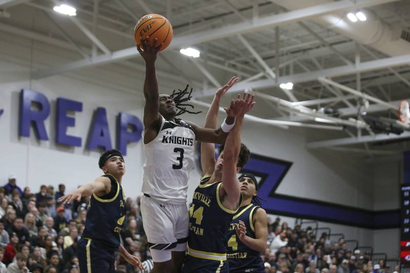 Kaneland's Marshawn Cocroft (3) puts up a layup attempt between the defense during their Plano Christmas Classic Championship basketball game between Yorkville Christian at Kaneland Tuesday, Dec 30, 2025 in Plano.
