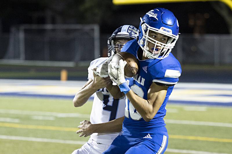 Newman’s Isaiah Williams turns after making a catch in front of Bureau Valley’s Brock Shane Friday, Sept. 29, 2023 in Sterling.