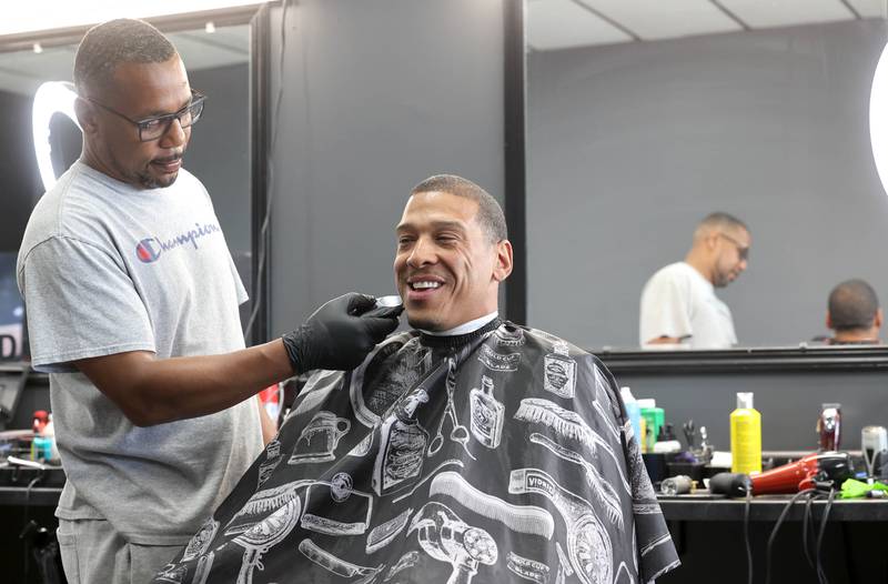 Newly elected DeKalb Ward 7 Alderman John Walker gets a hair cut from Lyndon Gay and talks about his first month as an alderman Thursday, June 1, 2023, at Roc's Barber Shop in DeKalb.