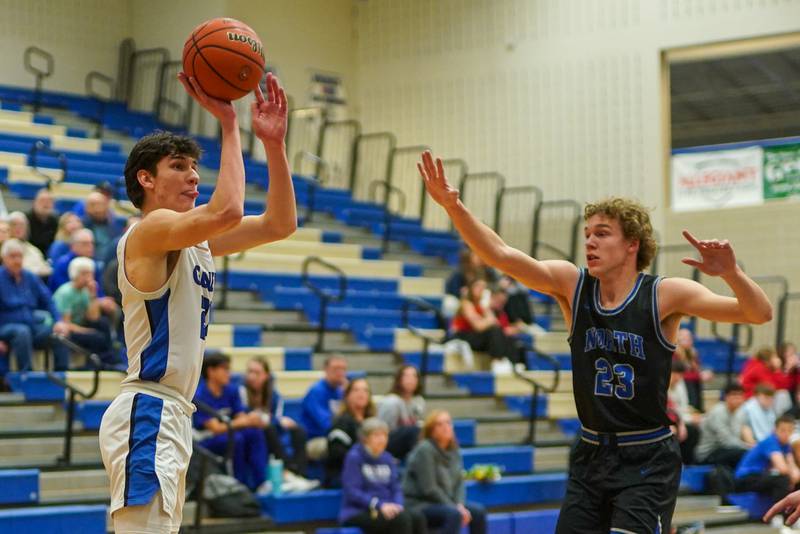 Geneva’s Luke Matan (24) shoots a three pointer against St. Charles North's Luke Holtz (23) during a basketball game at Geneva High School on Wednesday, Feb 14, 2024.