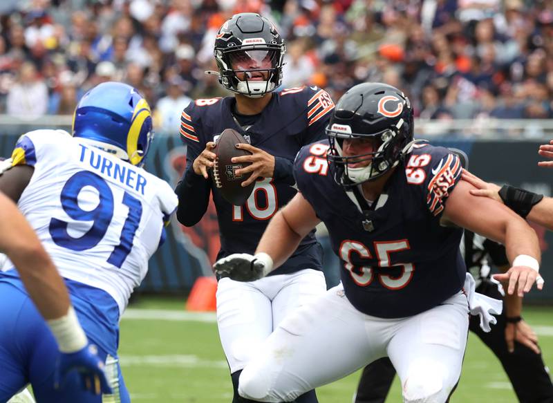 Chicago Bears quarterback Caleb Williams drops back to pass as Bears center Coleman Shelton prepares to block Los Angeles Rams defensive tackle Kobie Turner late in the first half of their game Sunday, Sept. 29, 2024, at Soldier Field in Chicago.