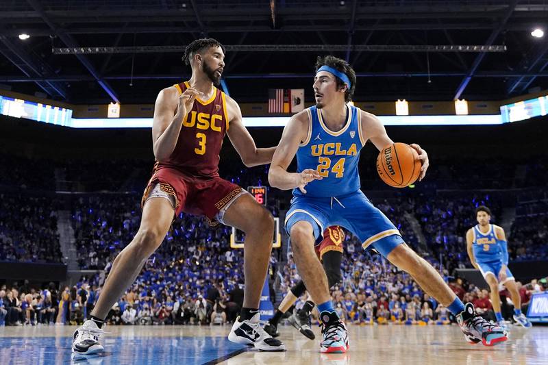 UCLA guard Jaime Jaquez Jr., right, tries to get by Southern California forward Isaiah Mobley during the second half on March 5, 2022, in Los Angeles. UCLA and Southern California are leaving the Pac-12 for the Big Ten in a seismic change that could lead to another major realignment of college sports.