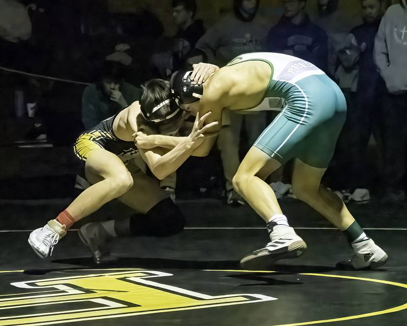 Riverdale's Kolton Kruse (left) grapples with Alleman's Adam Jacks during the 132-pound title bout at the 1A Riverdale Regional on Saturday, Feb. 4, 2023.