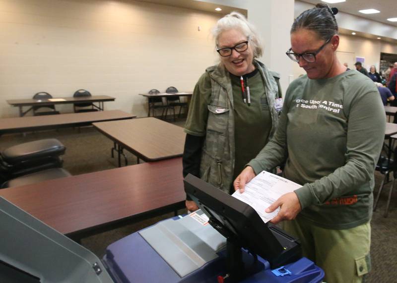 Brandy Miller of Ottawa, casts her ballot with the help of election judge Shawn McLaughlin on Tuesday, Nov. 5, 2024 at the Knights of Columbus Hall in Ottawa.