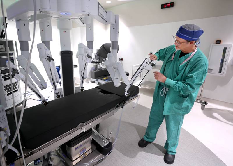 Dr. Jack Wagoner, associate chief medical officer at Northwestern Medicine Kishwaukee Hospital, slides an attachment into place on the da Vinci Xi robotic surgical system Tuesday, Oct. 28, 2025, in one of the operating rooms at the hospital in DeKalb. The hospital recently celebrated its 2,000th successful robotic-assisted surgery.