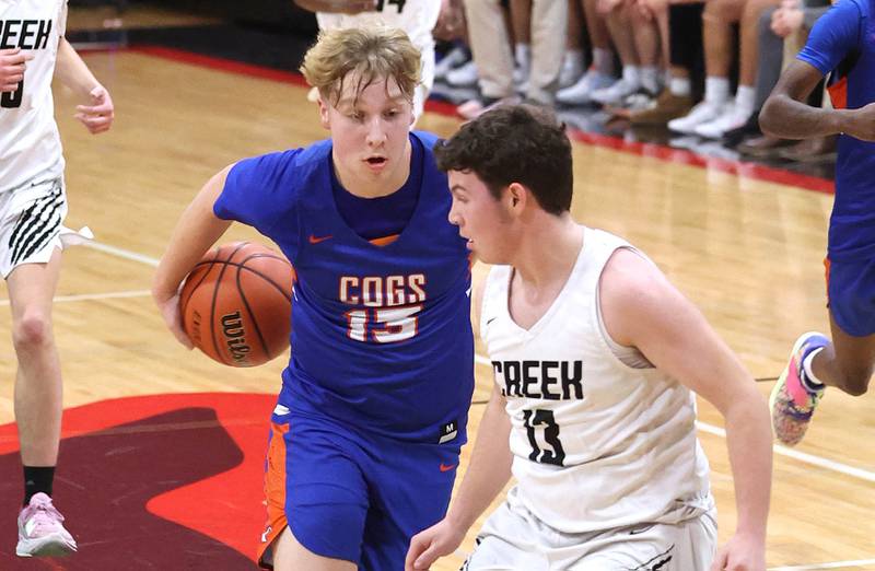 Genoa-Kingston's Hayden Hodgson goes around his back on his way to a layup over Indian Creek's Sam Genslinger Wednesday, Jan. 25, 2023, during their game at Indian Creek High School in Shabbona.
