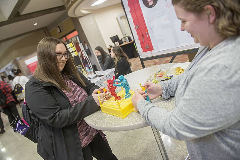 Mallory Newberry, left, of Sterling and Abigail Coons of Morrison play a knock-down-drag-out game of Rock'em, Sock'em Robots on Wednesday, April 20, 2022 during Sauk Valley Community College's Sauk Fest. The school held the afternoon of fun as a way for students to connect with clubs, college departments and community organizations.