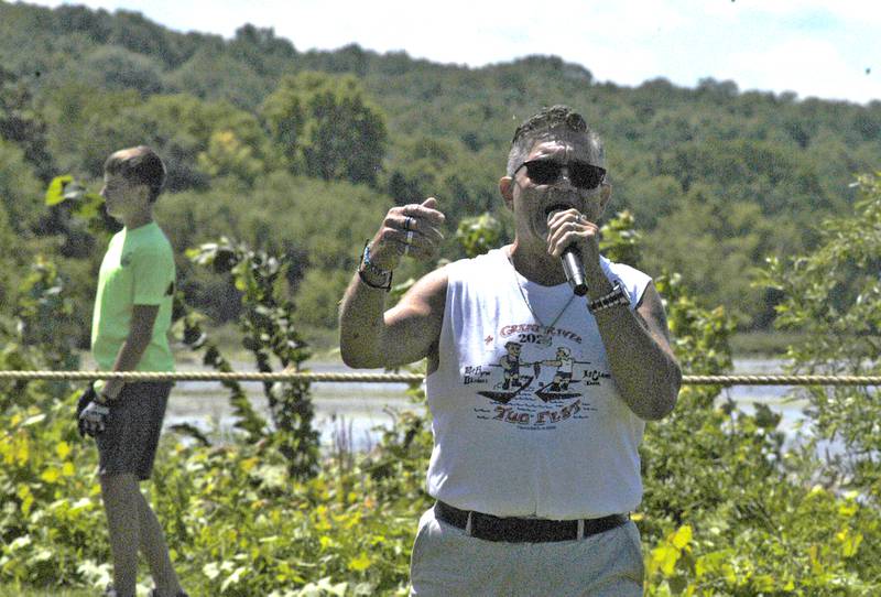 Tug MC Marty Russell gets the crowd warmed up at the Port Byron-hosted Great River Tug Fest across the Mississippi on Saturday, Aug. 10, 2024.