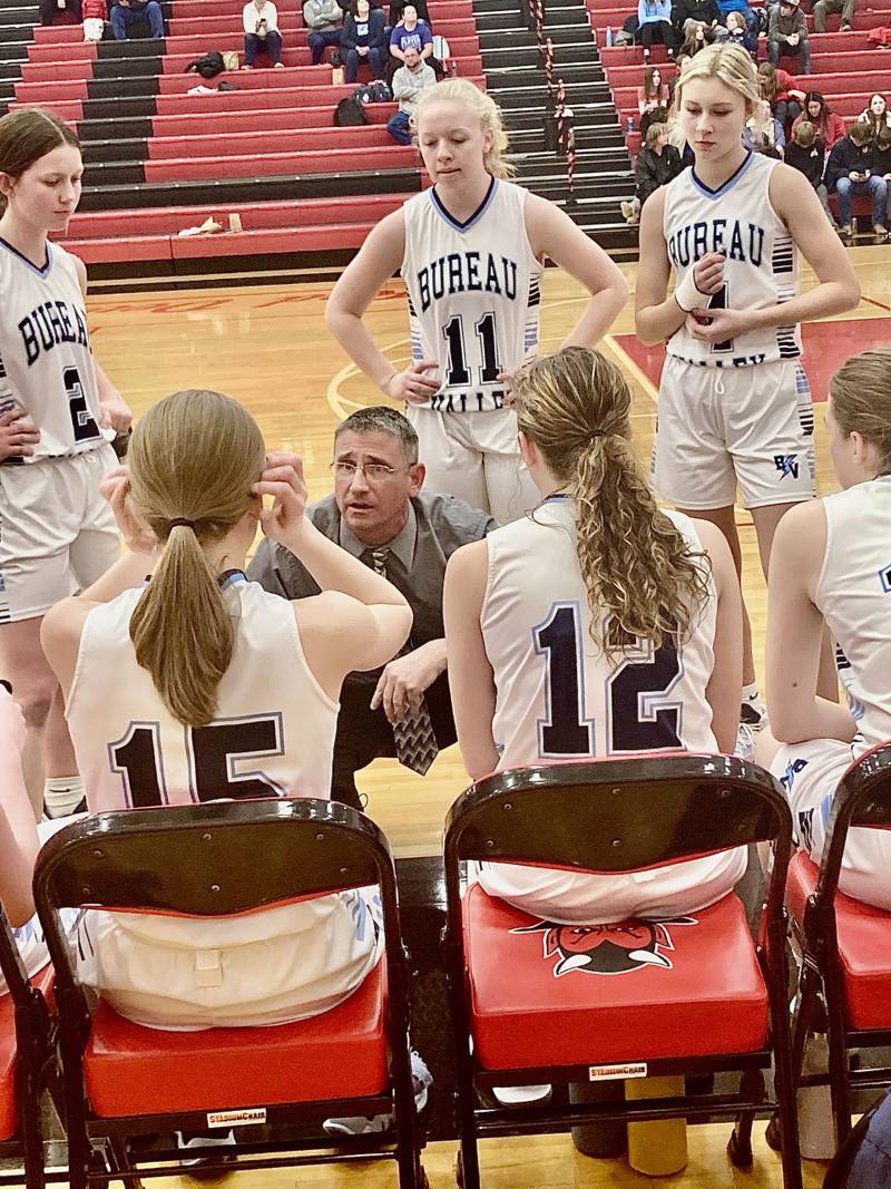 Bureau Valley coach Matt Wasilewski coaches his team during a timeout at Hall Thursday night. He lost his mother unexpectedly Monday morning, but has coached the Storm to two victories, because he said that's what his mom, a coach's wife, would have wanted him to do.