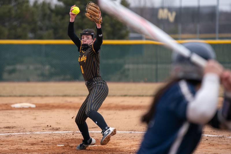 Metea Valley's Charlie Benesh (8) delivers a pitch against Oswego East during a softball game at Metea Valley High School in Aurora on Friday, Mar 24, 2023.