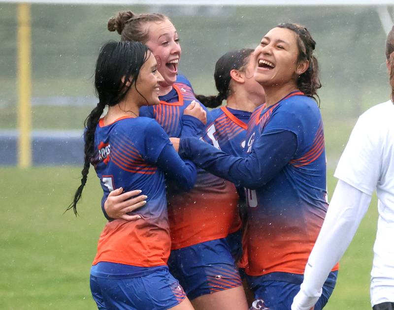 Genoa-Kingston players Jaida Modesto, (left) Ally Poegel and Jaquey Flores (right) celebrate after Poegel scored to put her team up 2-0 in their Class 2A regional final game against Rockford Christian Tuesday, May 20, 2025, at Rockford Christian High School.