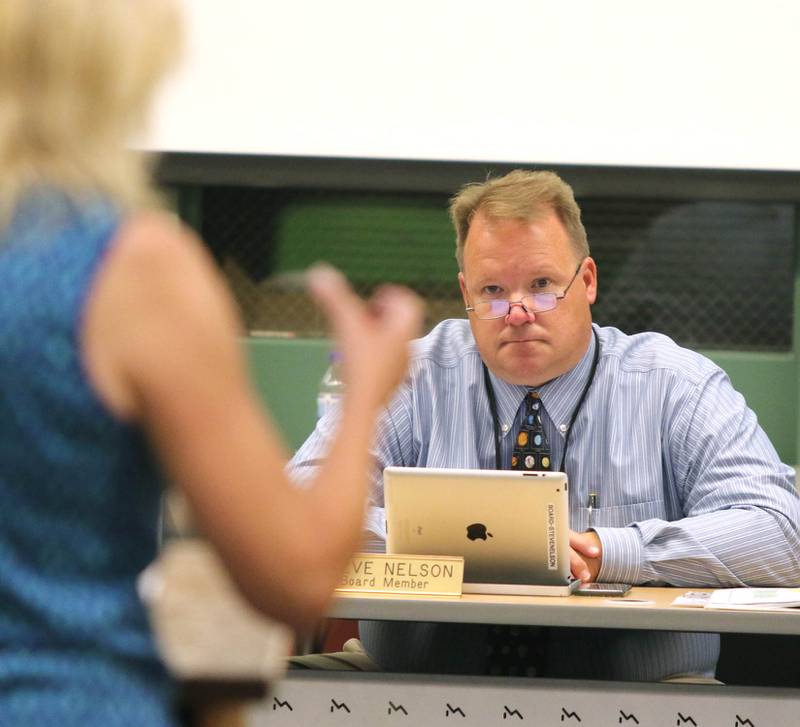 Sycamore School District 427 School Board member Steve Nelson listens to Lisa Feuerbach, who has children in the district, site statistics as she urges the board to not require students to wear masks when they return in the fall. A group of parents were in attendance Tuesday at the meeting at Sycamore High School requesting that the board make mask wearing optional for students in the district.