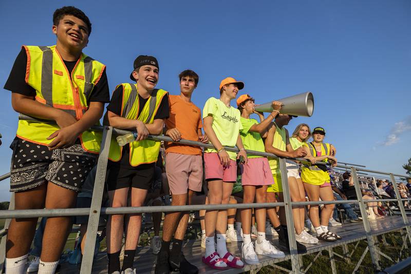 Dixon fans DeAaron Wilson (left), Gavin Kramer, Mason Weigle, Austin Hicks, Ben Oros, Alex Harrison, Nora Fordham and Charlie Cole celebrate their team Friday, August 25, 2023 as the football team opens against Stillman Valley.