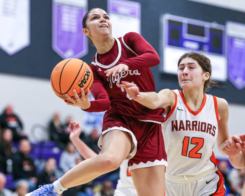 Plainfield North's Isabella Garcia (21) puts up an acrobatic shot during their WJOL Tournament Championship game between Plainfield North at Lincoln Way West on Saturday, November 23, 2024  in Joliet.