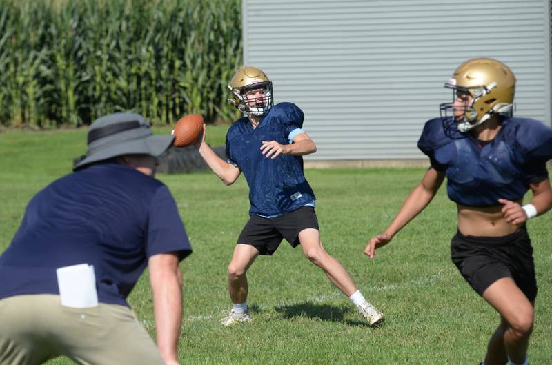 Polo High School players work on a pass play as head coach Ted Alston watches Wednesday, Aug. 13, 2025, in Polo.