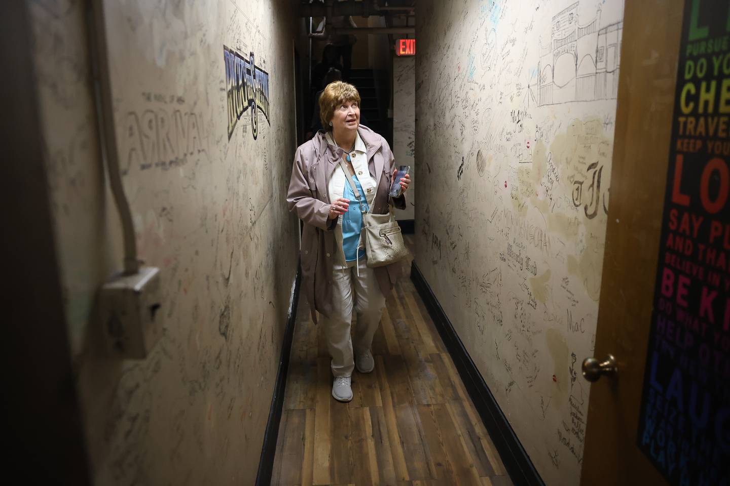 Jo Anne Vidmar looks at the hundreds of autographs of past performers back stage at the Rialto Theater’s 100th anniversary celebration on Sunday, May 3, 2026 in Joliet.