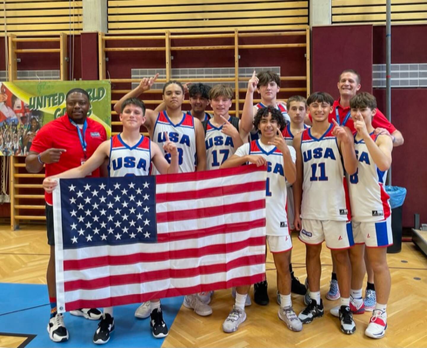 Darius Harrington (third from left) and Nico Battaglia (third from right) pose with the American flag after winning the 16U boys basketball championship at the United World Games in Klagenfurt, Austria on June 25, 2023.
