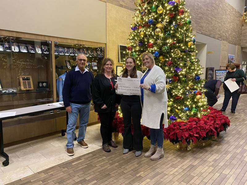 Grace E. donates $1,000 to Living Alternatives as a winner in the Community Foundation of Grundy County's essay contest.