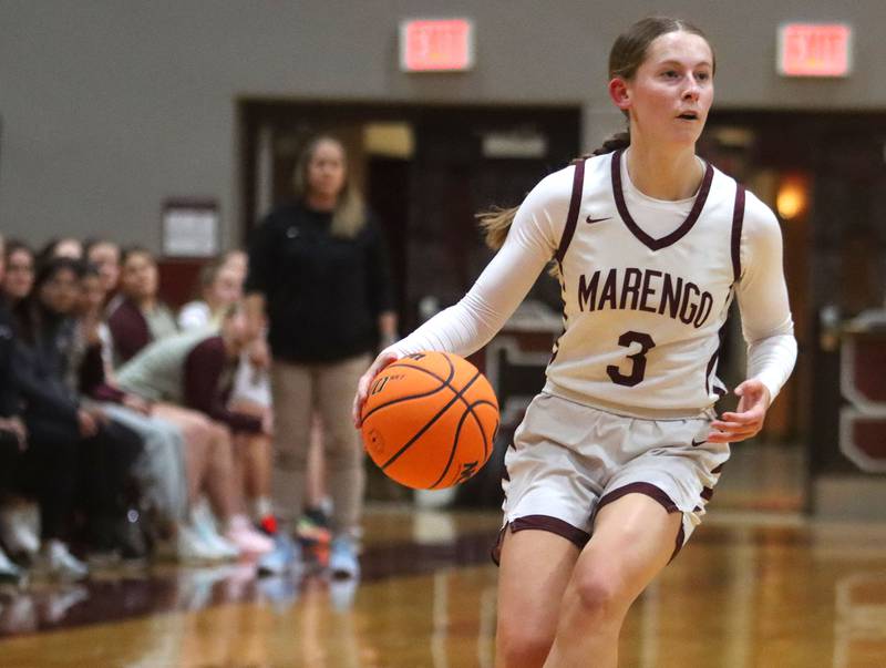 Marengo’s Maggie Hanson moves with the ball against Woodstock North in varsity girls basketball on Tuesday, Dec. 2, 2025, at Marengo High School in Marengo.