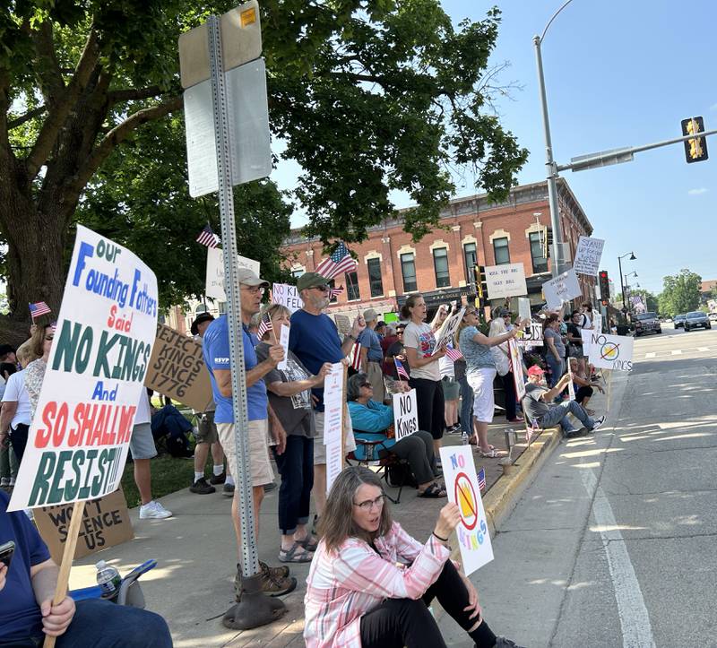 Attendees at the "No Kings" rally held in Oregon, Illinois on Saturday, June 14, 2025 hold their signs critical of the actions by President Donald Trump. An estimated 500 people attended the event, held on two sidewalks surrounding the historic Ogle County Courthouse.