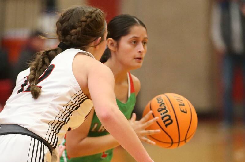 L-P's Nathali Aguirre looks to pass the ball off as Metamora's Addy Wooden defends during the Ottawa Girls Holiday Tournament on Monday, Dec. 16, 2024 in Kingman Gym at Ottawa High School.
