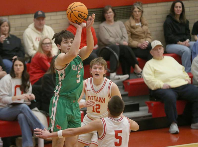 L-P's Erick Sotelo shoots a jump shot between Ottawa's Rory Moore and Jack Carroll on Friday, Feb. 6, 2026 in Kingman Gymnasium at Ottawa High School.