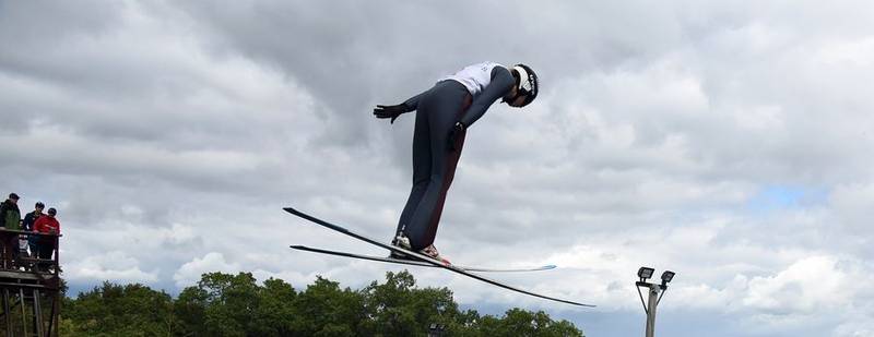 A jumper leaps high above Fox River Grove on Sunday, Sept. 25, 2022, during the Norge Ski Club's annual Fall Ski Jumping Competition, also known as Jumptoberfest.