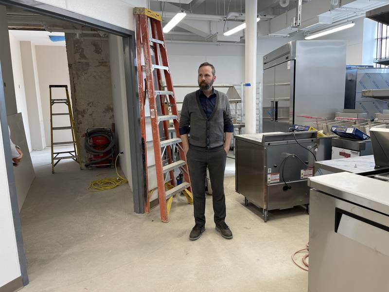 Woodstock City Planner Darrell Moore stands in one of the new kitchen spaces and listens to Mayor Mike Turner (off camera) in the Old Courthouse and Sheriff's House on Thursday, May 25, 2023.